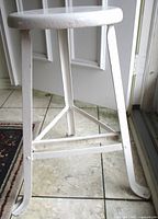 Full view of stool showing seat and legs