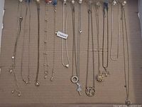 All 13 necklaces displayed on cardboard for overview