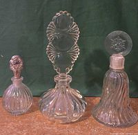 three clear glass perfume bottles group view