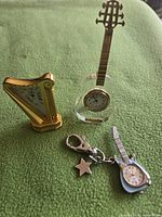 All three miniature clocks grouped on fabric background