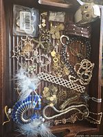 Overview of all jewelry pieces laid in wooden tray