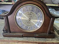 Front view of Bulova Chadbourne mantel clock showing full wooden case and dial