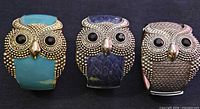 Front view showing all three owl bracelets with color variations