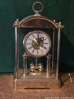 Front view of Daniel Dakota mantel clock showing dial, case, pendulum