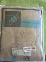 Front of packaged curtain panel showing branding and material