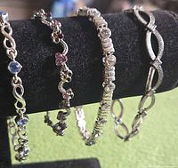 Four bracelets on black display showing overall designs
