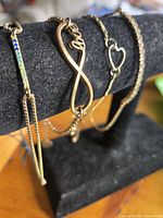 Four bracelets on display stand showing connectors