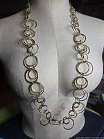 Necklace displayed on mannequin showing length and graduated circular links