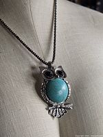Owl pendant on mannequin showing size and pendant details