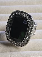 Front view of ring showing black stone and rhinestone halo