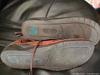 Soles of both sandals showing tread and Rieker logo
