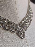Close-up of rhinestone bib necklace drape and stone setting