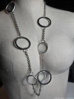 Necklace on dress form showing full length and ring arrangement