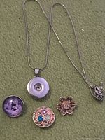 Full view of necklace and three snap charms laid out