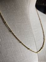 Necklace draped on mannequin torso showing overall appearance and bead spacing