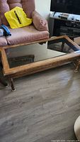Full view of rectangular wood coffee table with glass inset top