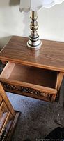 Nightstand with drawer open showing carved front and hardware
