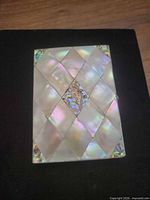 Front view showing iridescent mother-of-pearl diamond pattern exterior