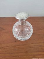 Front view showing cut glass pattern and silver cap