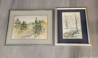 Both framed watercolour paintings side by side on floor