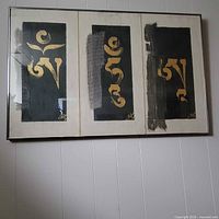 Full view of framed artwork showing three panels