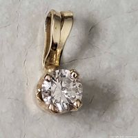 Front view of gold pendant showing stone and bail