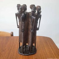 Front view of four-figure ebony sculpture
