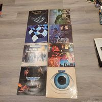 Eight album covers laid out on floor