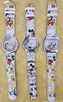 Front view of three watches showing dials and straps