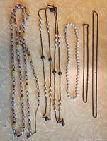 Full view of all five necklaces laid out