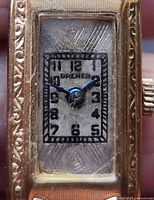 Close-up of Bremen watch dial showing logo, numerals, hands and crystal wear