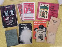 All nine books and pamphlets laid out together