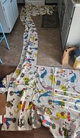 Long circus-print curtain laid out on floor