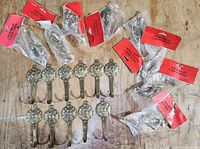 All 20 brass hooks laid out, showing quantity and two designs