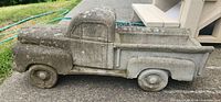 Side view of full concrete pickup truck planter