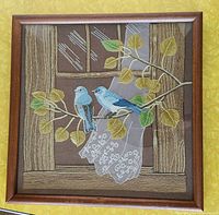 Front view of framed embroidery showing full scene
