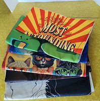 Stack of printed cushion covers showing multiple designs