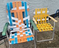 Front view of both folding chairs showing size difference and webbing condition