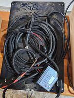 Back of solar panel with bundled wiring and controller attached