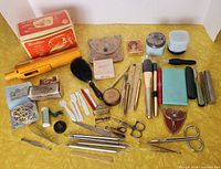 Full layout of entire lot showing curling iron, jars, travel iron, brush, compact, many small tools and accessories