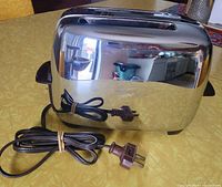 Front and side view showing chrome body and attached cord