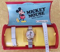 Watch in open plastic Bradley display case with spare white strap