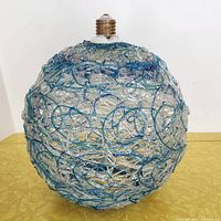 Front view of spherical shade showing spaghetti acrylic pattern