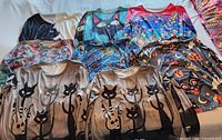 All eight shirts laid out showing front graphics