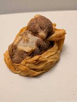 Overall view of Aynsley sleeping mouse figurine showing mouse detail and nest