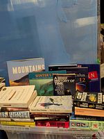 Crate of mixed books showing titles and formats