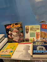 Front view of all items including Clue puzzle, Mindbender game, four books