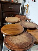 Five scratched round wooden boards on shelf
