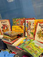 Overall lot showing stacked and upright children’s books