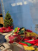 Group view showing tree, red platter, textiles, tinsel